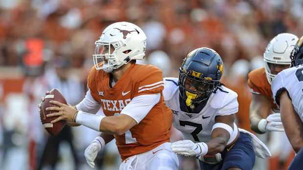 Oct 1, 2022; Austin, Texas, USA; West Virginia Mountaineers linebacker Jasir Cox (7) sacks Texas Longhorns quarterback Hudson Card (1) during the first quarter at Darrell K Royal-Texas Memorial Stadium.